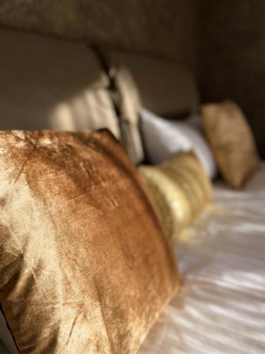 a close up of a bed with pillows and a blanket at Magnolia House with Indoor Swimming Pool and Sauna in Tallinn