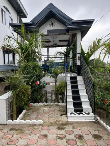 a house with a staircase leading to the front door at Apex guest facility in Buea