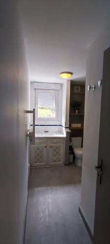 a bathroom with a sink and a toilet at Logement lumineux bord de forêt in Aubenas