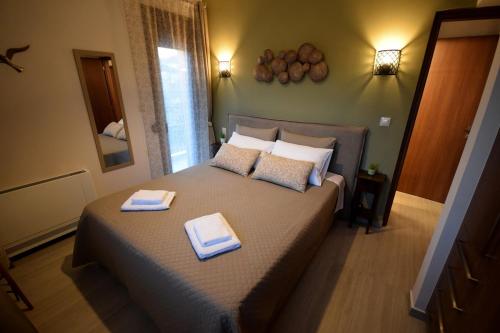 a bedroom with a bed with two towels on it at Reggina Apartment in Arta