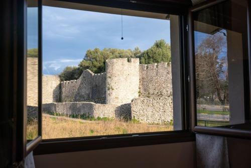 a view of a castle from a window at Reggina Apartment in Arta