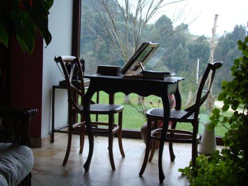 a desk with two chairs and a computer on it at A Casa de Mañas in Mondoñedo