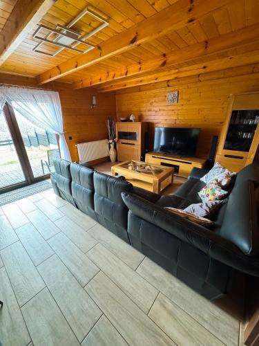 a living room with a couch and a table at Beskidzki Domek Kurów in Kurów