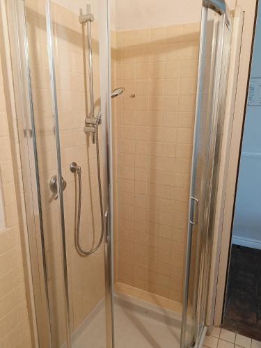 a shower with a glass door in a bathroom at B&B La Quercia in Moncalvo