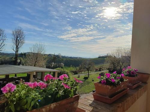a view of a garden with flowers on a balcony at B&B La Quercia in Moncalvo