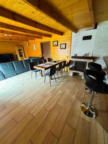 a room with a table and chairs and a piano at Beskidzki Domek Kurów in Kurów
