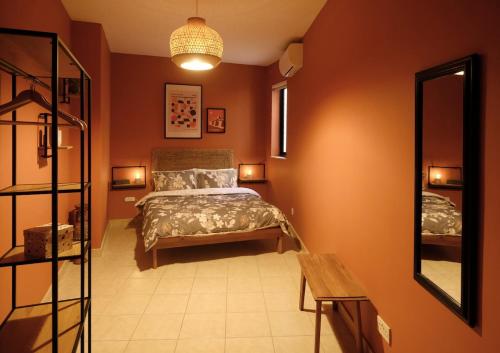a bedroom with a bed and a mirror at Spacious 3 Bed Apartment in Vibrant St Julians in Tal-Għoqod