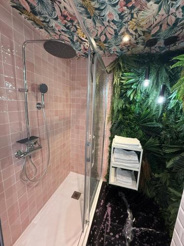 a bathroom with a shower with plants on the wall at Apartamento 951 in Granada