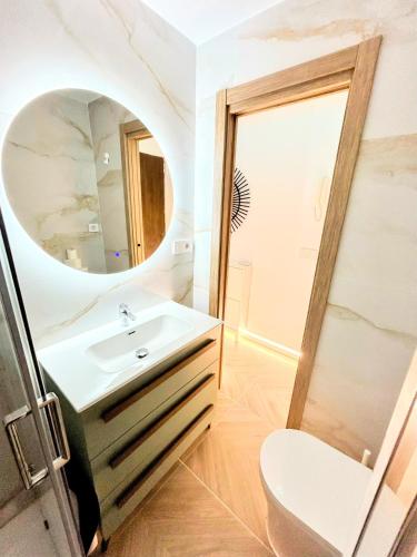 a bathroom with a sink and a mirror at Luxury studio Torremolinos Costa del Sol in Torremolinos