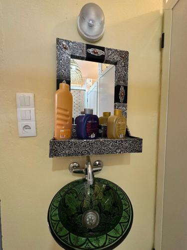 a bathroom sink with a mirror and a sink at Red Vibes Marrakech in Marrakesh