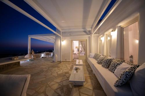 a living room with a white couch and a table at Lux Private Estate Endless Sea & Sky View in Plintri