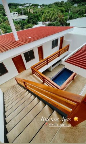 arial view of a house with stairs in front of it at Villa Tortuga San Juan del Sur in San Juan del Sur