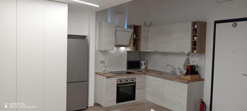 una cucina con mobili bianchi e un forno a piano cottura di Casa del viaggiatore a Molfetta
