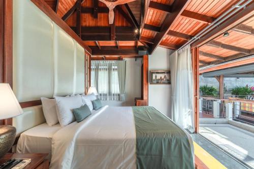 a bedroom with a large bed and a large window at Villa Gecko with sea view pool, walk to Beach & Restaurants in Surin Beach