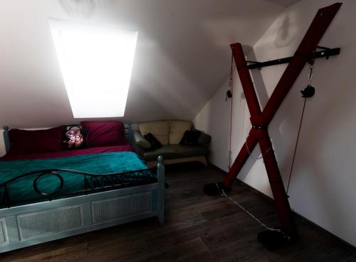 a room with a bed and a tripod next to a window at Stylish new "PLAYGROUND" flat with Bondage Cross & Private fitness in new family house in Hradec Králové