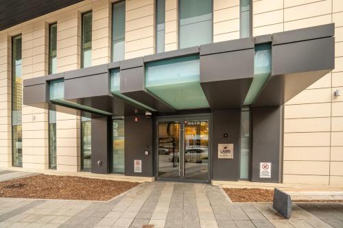 a building with a revolving door in front of it at Stylish Condo with Exclusive Rooftop Pool in Calgary