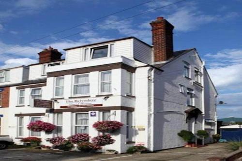 a white building with flowers in front of it at Belvedere Guest House, Great Yarmouth in Great Yarmouth