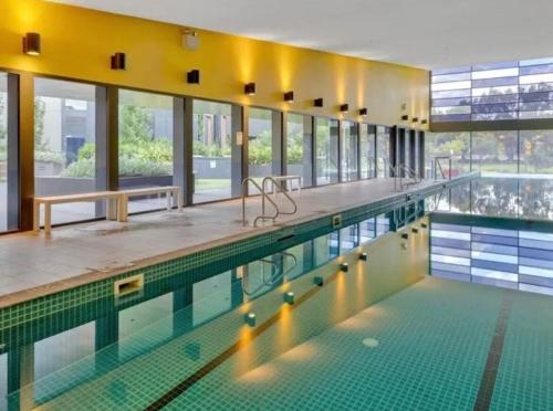 a large swimming pool with a large amount of windows at City Fringe Oasis - Pool, Gym & Car Park in Melbourne