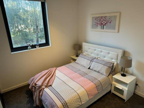 a bedroom with a bed and a window at City Fringe Oasis - Pool, Gym & Car Park in Melbourne