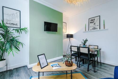 a living room with a table and a dining room at 17 Anfield House sleeps 12 7min walk to stadium in Liverpool