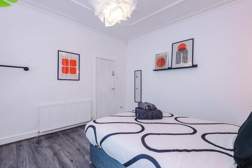 a bedroom with a bed with a black and white blanket at 17 Anfield House sleeps 12 7min walk to stadium in Liverpool