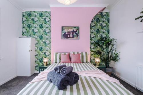 a bedroom with a bed with towels on it at 17 Anfield House sleeps 12 7min walk to stadium in Liverpool