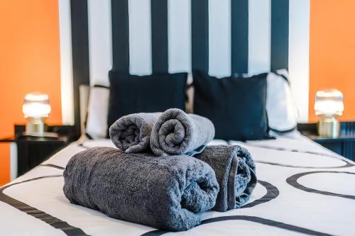 a pile of towels sitting on top of a bed at 17 Anfield House sleeps 12 7min walk to stadium in Liverpool
