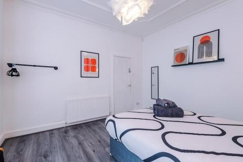 a bedroom with a bed in a white room at 17 Anfield House sleeps 12 7min walk to stadium in Liverpool