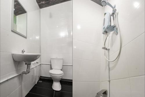 a bathroom with a sink and a toilet and a shower at Hotel O Hi Inn 3 in Sibu