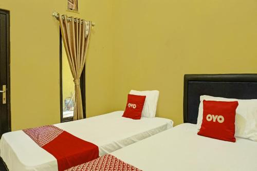 Ένα ή περισσότερα κρεβάτια σε δωμάτιο στο Hotel O Sweet Candy 1 Syariah