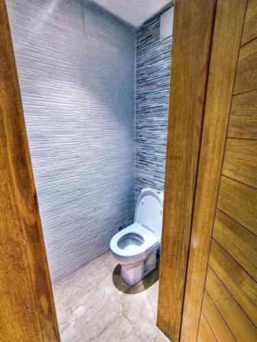 a bathroom with a white toilet in a stall at Appartement Imi ouaddar Bord de mer acces direct plage in Imi Ouaddar