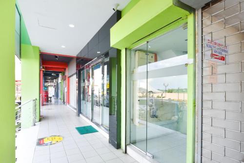 a store front with glass doors on a building at Hotel O G Home Hotel, Kota Bharu, Kelantan. in Kota Bharu
