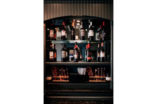 a shelf filled with lots of bottles of alcohol at OYO The Leven in Stokesley