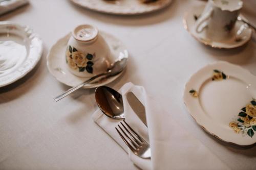 a table with plates and utensils on a table at OYO The Leven in Stokesley