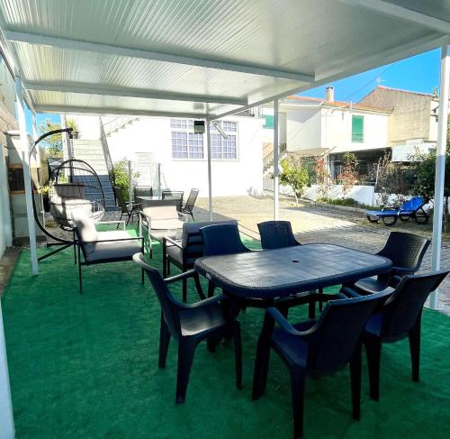 a patio with a table and chairs under a canopy at Alojamento Local Afonso in Macedo de Cavaleiros