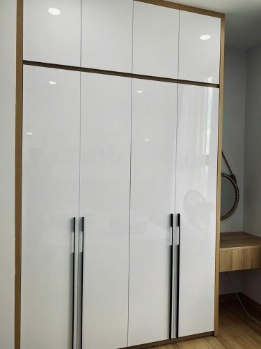 a white cabinet with two doors in a room at Vina Apartment- Căn hộ trung tâm Huế in Thôn Trường Giang