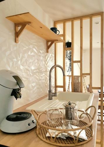 une cuisine avec un évier et un plan de travail dans l'établissement T2 NEUF - 8min de Lyon - Parking privé -Terrasse, à Irigny