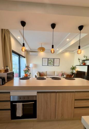 a kitchen with a large island in a living room at Cozy 2 bedrooms flat at Dar Bouazza in Dar Bouazza