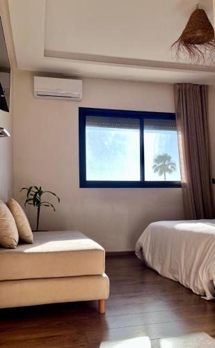 a bedroom with a bed and a window at Cozy 2 bedrooms flat at Dar Bouazza in Dar Bouazza