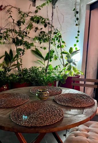 a wooden table with plates on it with plants at Cozy 2 bedrooms flat at Dar Bouazza in Dar Bouazza