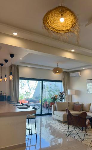 a living room with a couch and a table at Cozy 2 bedrooms flat at Dar Bouazza in Dar Bouazza