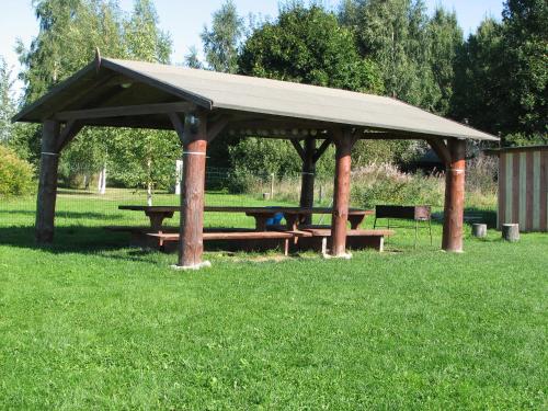 a picnic shelter with a picnic table in a field at Kolkja Holiday Centre in Kolkja
