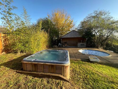 a hot tub in a yard next to a house at 5 bed house with hot tub in Powick