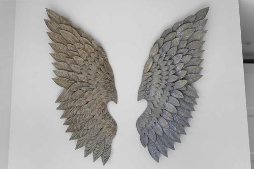 a pair of metal wings hanging on a wall at Breathtaking Views of the Pacific Ocean Rooftop Balcony Gourmet Kitchen and Hot Tub overlooking Golf Course in Bodega Bay