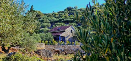 a small house sitting on top of a hill at Villa Broč in Postira