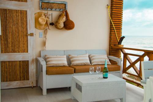 a living room with a couch and a table at Laguna Beach, Brisa Marina playa Frances in Coveñas