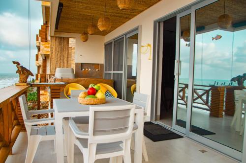 a dining room with a table with fruit on it at Laguna Beach, Brisa Marina playa Frances in Coveñas