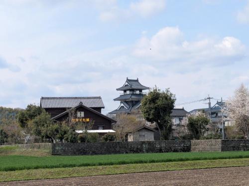 a house with a pagoda on top of it at 民泊サライ七城 in Kikuchi