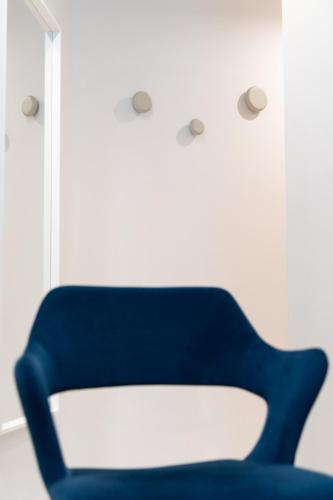 a blue chair sitting next to a window at La Caravella in Loano