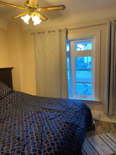 a bedroom with a bed and a window at Oshawa Duplex in Oshawa